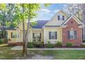 Inviting home with a covered porch, rocking chairs, and attractive landscaping at 15 Cole Creek Way, Franklinton, NC 27525