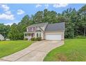 Attractive two-story home with a long driveway and well-manicured lawn at 161 Jacob St, Holly Springs, NC 27540