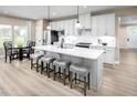 Bright kitchen featuring an island with barstool seating, stainless steel appliances, and a dining area at 196 Glen Hollow Dr, Raleigh, NC 27604