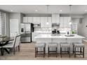 Bright kitchen featuring white cabinetry, stainless steel appliances, and an island with seating at 197 Glen Hollow Dr, Raleigh, NC 27604