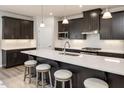 Modern kitchen with sleek cabinetry, a spacious island, and stainless steel appliances, ideal for cooking enthusiasts at 198 Glen Hollow Dr, Raleigh, NC 27604