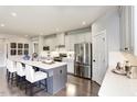 Modern kitchen featuring stainless steel appliances, sleek countertops, and a stylish center island with seating at 199 Glen Hollow Dr, Raleigh, NC 27604