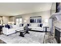 Bright living room showcasing a comfortable seating area, stylish decor, and a decorative stone fireplace at 199 Glen Hollow Dr, Raleigh, NC 27604