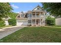 Charming two-story home with a spacious front yard, a two-car garage, and a welcoming porch at 2027 River Grove Ln, Knightdale, NC 27545
