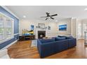 Inviting living room featuring a fireplace, hardwood floors, and blue accent wall at 2027 River Grove Ln, Knightdale, NC 27545