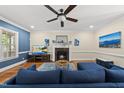 Cozy living room boasts a beautiful fireplace, hardwood floors, and a stylish blue sofa at 2027 River Grove Ln, Knightdale, NC 27545