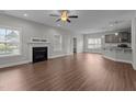 Spacious living area featuring a cozy fireplace and seamless transition to the modern kitchen at 2057 Big Falls Dr, Wendell, NC 27591