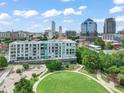 Aerial view of community buildings, skate park, and green space with a beautiful skyline in the background at 214 Hunt St # 701, Durham, NC 27701