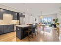 Modern kitchen with stainless steel appliances, island with breakfast bar, and open floor plan at 214 Hunt St # 701, Durham, NC 27701