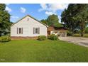 Traditional home showcasing a well-manicured lawn, shuttered windows, and an attached two-car garage at 2257 Delaney Dr, Burlington, NC 27215