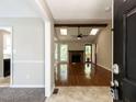 Open living room featuring hardwood floors, vaulted ceiling, and brick fireplace at 23 Joci Ct, Durham, NC 27704