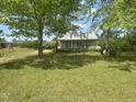 Quaint home with a large, green front lawn and mature trees providing ample shade at 248-A Gilbert Rd, Benson, NC 27504