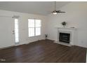 Spacious living room featuring a fireplace, hardwood flooring, and ample natural light at 2662 Walas Ct, Creedmoor, NC 27522