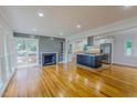 Spacious living room showcasing wood floors, a fireplace, and an open kitchen concept at 303 Winhaven St, Roxboro, NC 27573