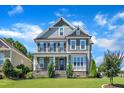 Charming two-story home with stone accents, manicured lawn, and inviting front porch at 503 Bendemeer Ln, Rolesville, NC 27571