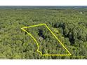An aerial view highlighting the generous acreage of the property, outlined by yellow property lines at 5216 Woods End Rd, Hillsborough, NC 27278