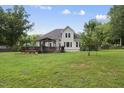 The home features a large backyard with a deck, a pergola, and established trees at 55 Kristopher Woods Dr, Youngsville, NC 27596