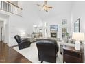 Bright living room with a fireplace, high ceilings, and hardwood floors at 55 Kristopher Woods Dr, Youngsville, NC 27596