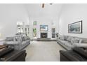 Spacious living room with fireplace, large windows, and neutral decor at 55 Kristopher Woods Dr, Youngsville, NC 27596