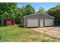 Features a practical two-car garage and an adjacent red shed, perfect for storage and hobbies at 6022 Little Creek Church Rd, Clayton, NC 27520