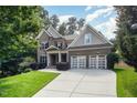 Beautiful two-story brick home with a manicured lawn and a convenient two-car garage at 7809 Chestnut Branch Ct, Raleigh, NC 27612