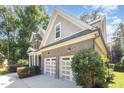 Side view of the home shows a spacious two-car garage and well-maintained landscaping at 7809 Chestnut Branch Ct, Raleigh, NC 27612