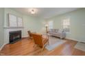 Bright living room featuring a fireplace, hardwood floors, and comfortable seating area at 8 Mandy Ct, Durham, NC 27707