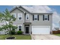 Charming front exterior with gray siding, white trim, and a well-maintained lawn at 8005 Caithness St, Raleigh, NC 27616