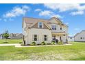 Charming two-story home with a well-maintained lawn and welcoming front porch at 81 Olive Branch Dr, Smithfield, NC 27577