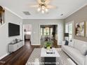 Elegant, virtually staged living room with modern decor, connecting seamlessly to the dining area and kitchen at 8640 Swarthmore Dr, Raleigh, NC 27615