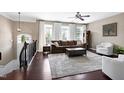 Bright living room featuring large windows, hardwood floors, and comfortable seating at 8715 Macedonia Lake Dr, Cary, NC 27518