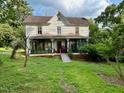 Two-story home featuring an accessible ramp and a screened-in porch, set amid a grassy front yard at 94 Bynum Church Rd, Pittsboro, NC 27312