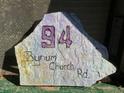 A decorative rock sign displays the address '94 Bynum Church Rd' in painted lettering at 94 Bynum Church Rd, Pittsboro, NC 27312