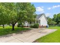 Charming single-story home with a long driveway, well-maintained lawn, and inviting front porch at 99 Winwood Dr, Angier, NC 27501
