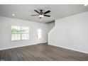 Bright living room with a ceiling fan, lots of natural light, and neutral paint at 1004 Rhino Bnd, Oxford, NC 27565