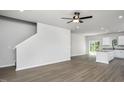 Open-concept living room with stairs, neutral paint, and laminate flooring throughout at 1004 Rhino Bnd, Oxford, NC 27565