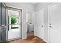 Light-filled entryway features hardwood floors, glass door, laundry room, and a coat closet at 1019 Santiago St, Durham, NC 27703