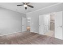 Spacious main bedroom with carpet, a ceiling fan and ensuite bathroom and a doorway to another room at 1019 Santiago St, Durham, NC 27703