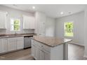 Bright kitchen with an island, granite countertops, stainless steel appliances, and natural light at 102 Flue Ct, Oxford, NC 27565