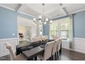 Bright dining room with coffered ceilings, wainscoting, and view into the adjacent office at 103 Foothill Ct, Sanford, NC 27330
