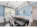 Elegant dining room featuring coffered ceilings, modern chandelier, and stylish decor at 103 Foothill Ct, Sanford, NC 27330