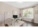 Well-lit office space with a window, desk, and hardwood floors, perfect for remote work at 103 Foothill Ct, Sanford, NC 27330