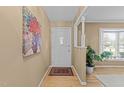 Bright entryway featuring hardwood floors, fresh paint and updated lighting fixtures at 1040 Ivy Ln, Cary, NC 27511