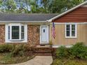 Close-up of a house with a front door and well maintained yard and walkway at 1040 Ivy Ln, Cary, NC 27511