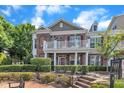 Brick townhouse featuring a second-story balcony and well-maintained landscaping at 10511 Sablewood Dr # 107, Raleigh, NC 27617