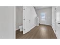 Welcoming entryway featuring beautiful hardwood floors, access to a half bath, and natural light at 111 Rhino Bnd, Oxford, NC 27565