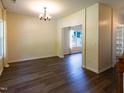 Bright dining room featuring hardwood floors, elegant lighting, and view to yard through large windows at 1122 Birkdale Dr, Mebane, NC 27302