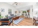 Inviting living room with hardwood floors, a comfortable sofa, and an open layout leading to the dining area and kitchen at 1203 First Street Ext, Nashville, NC 27856