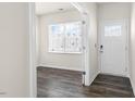 Inviting foyer with wood-look floors, a white front door, and natural light from the window at 132 Pisgah St, Sanford, NC 27330