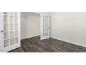 Bright room with wood-look floors and glass paneled french doors at 132 Pisgah St, Sanford, NC 27330